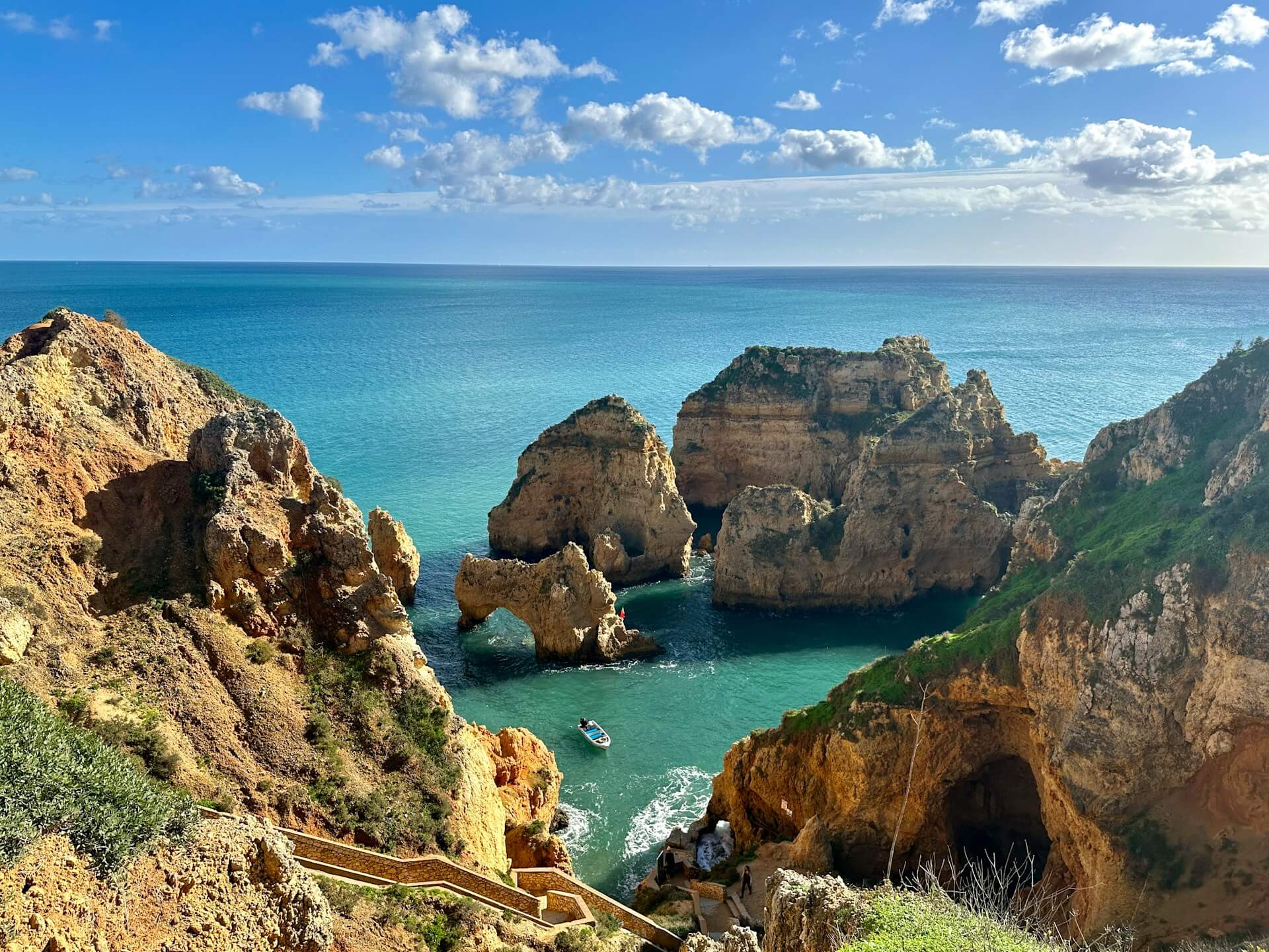 a beach with a rocky cliff