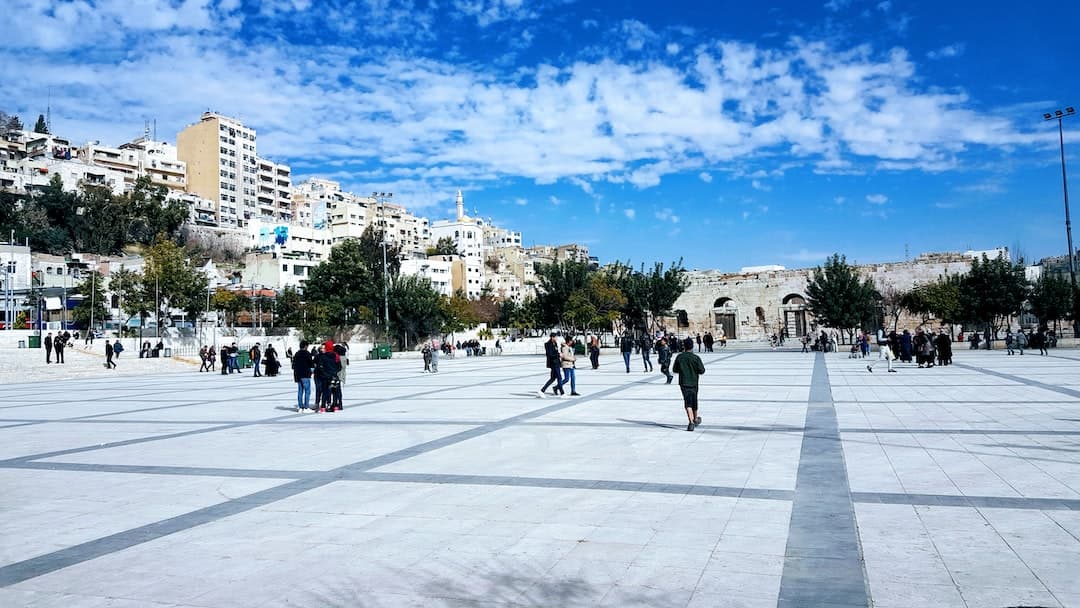 a group of people walking around a large open area