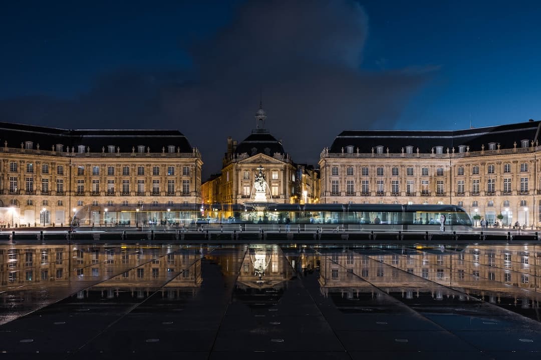 a reflection of a building in a body of water