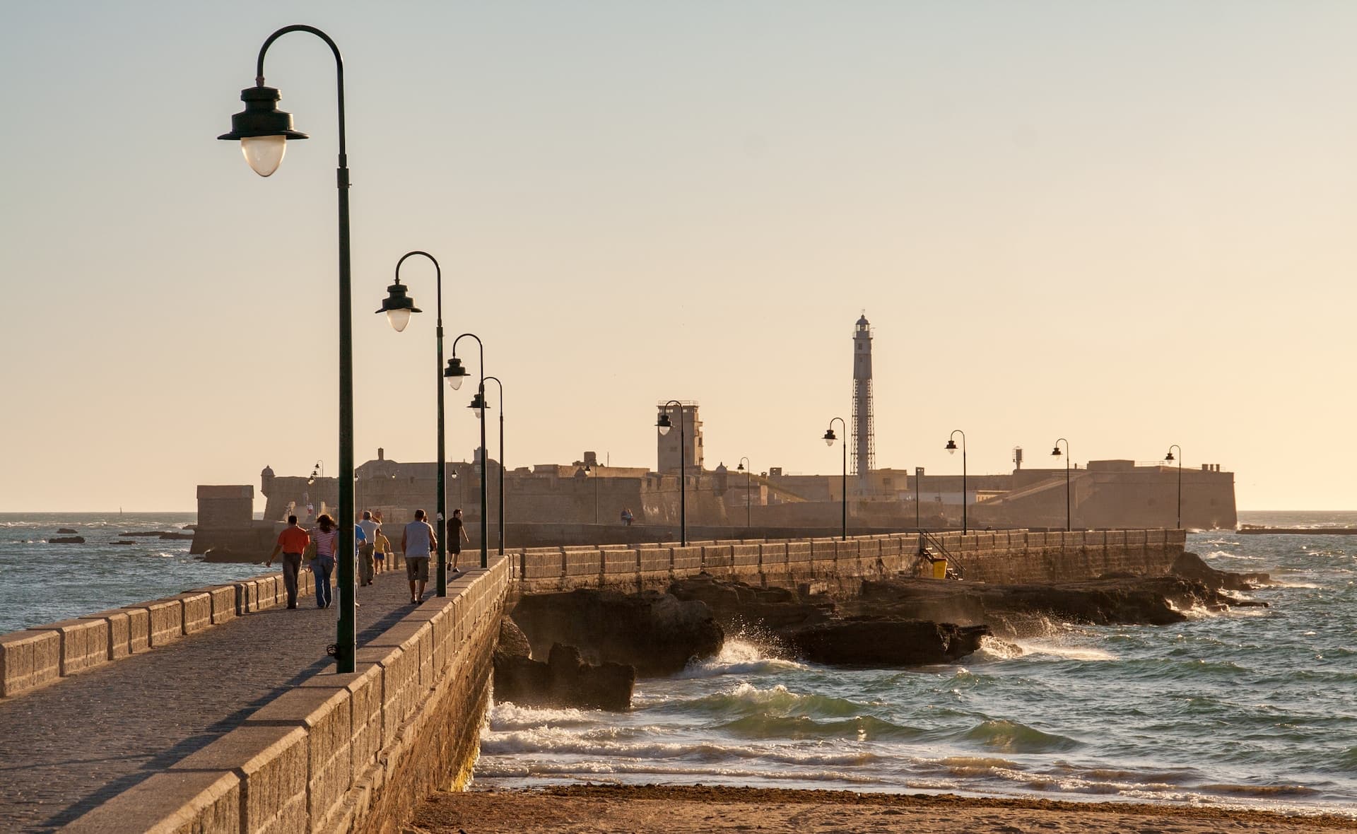 people walking on the bridge over the river during the day