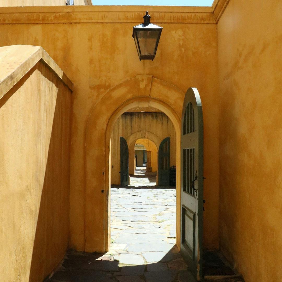 a narrow alley way with a light hanging over it