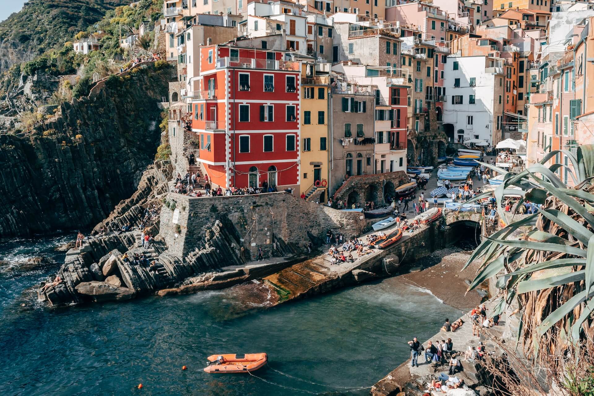 a view of a village on a cliff overlooking the ocean