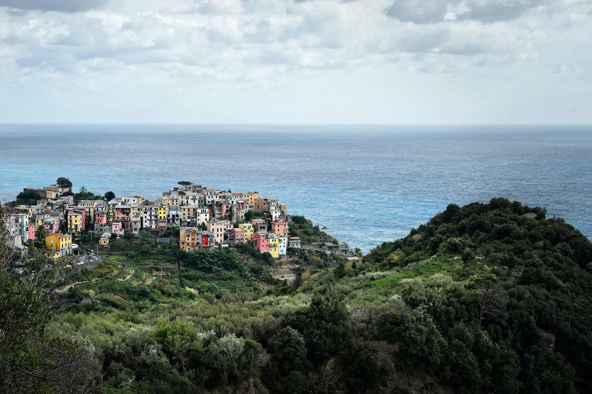 a view of a village on a cliff overlooking the ocean