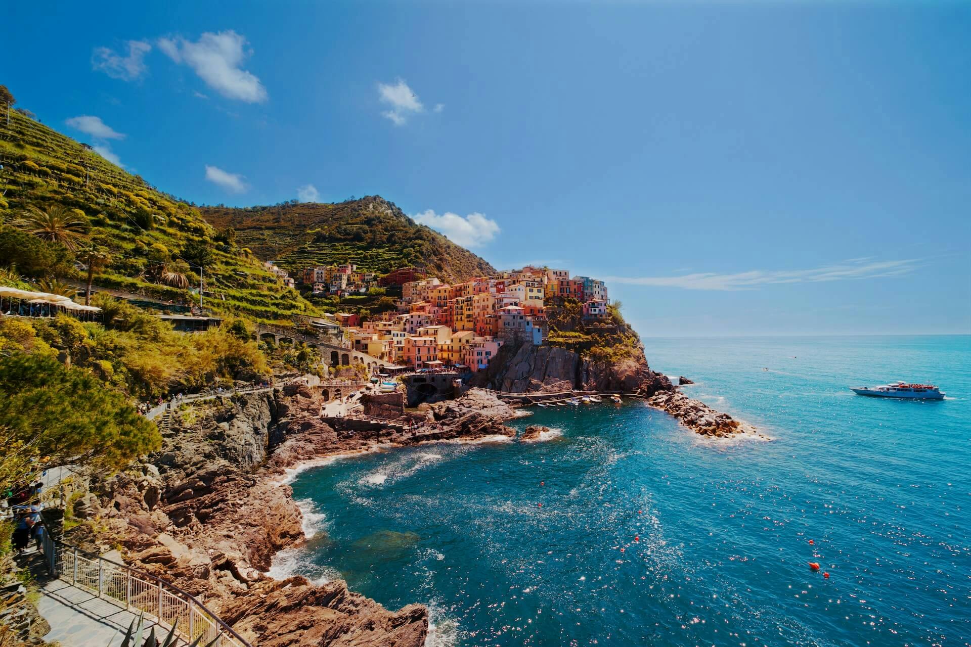 a view of a village on a cliff overlooking the ocean