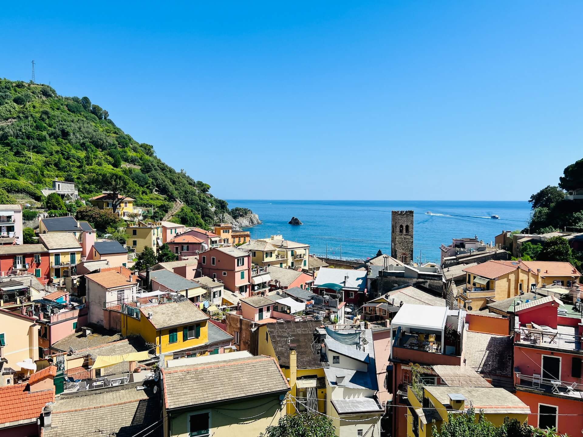 a view of a village on a cliff overlooking the ocean