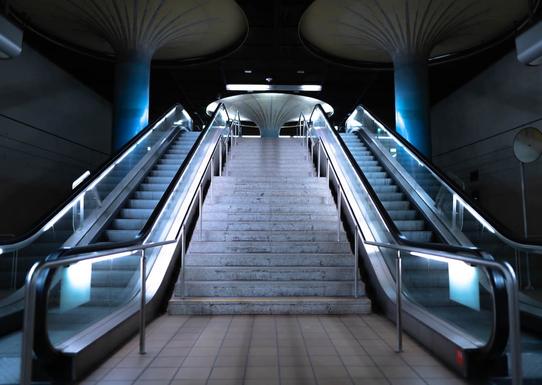 gray and black escalator in a room