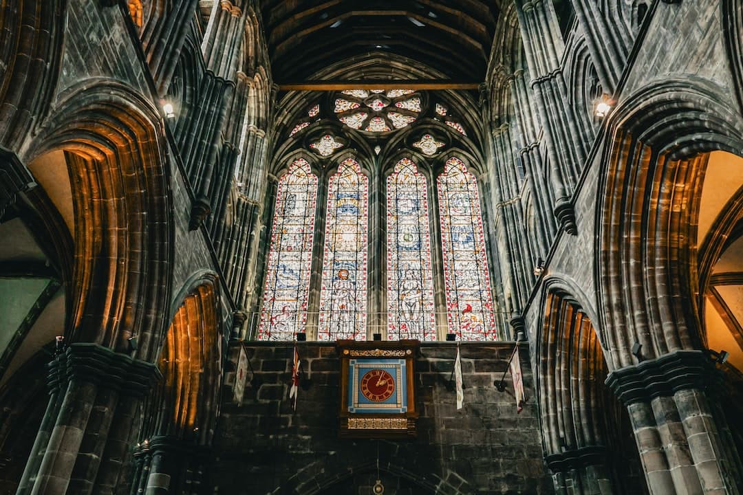 the interior of a cathedral with stained glass windows