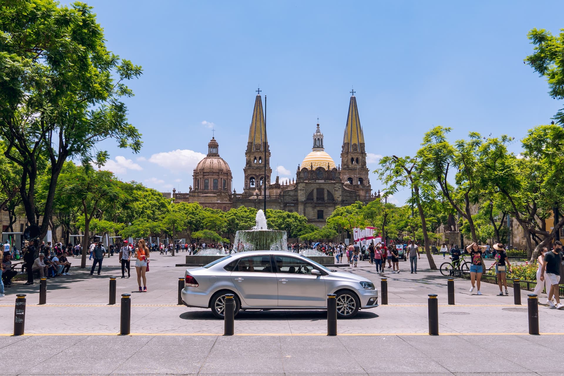 cars parked beside brown concrete building during daytime