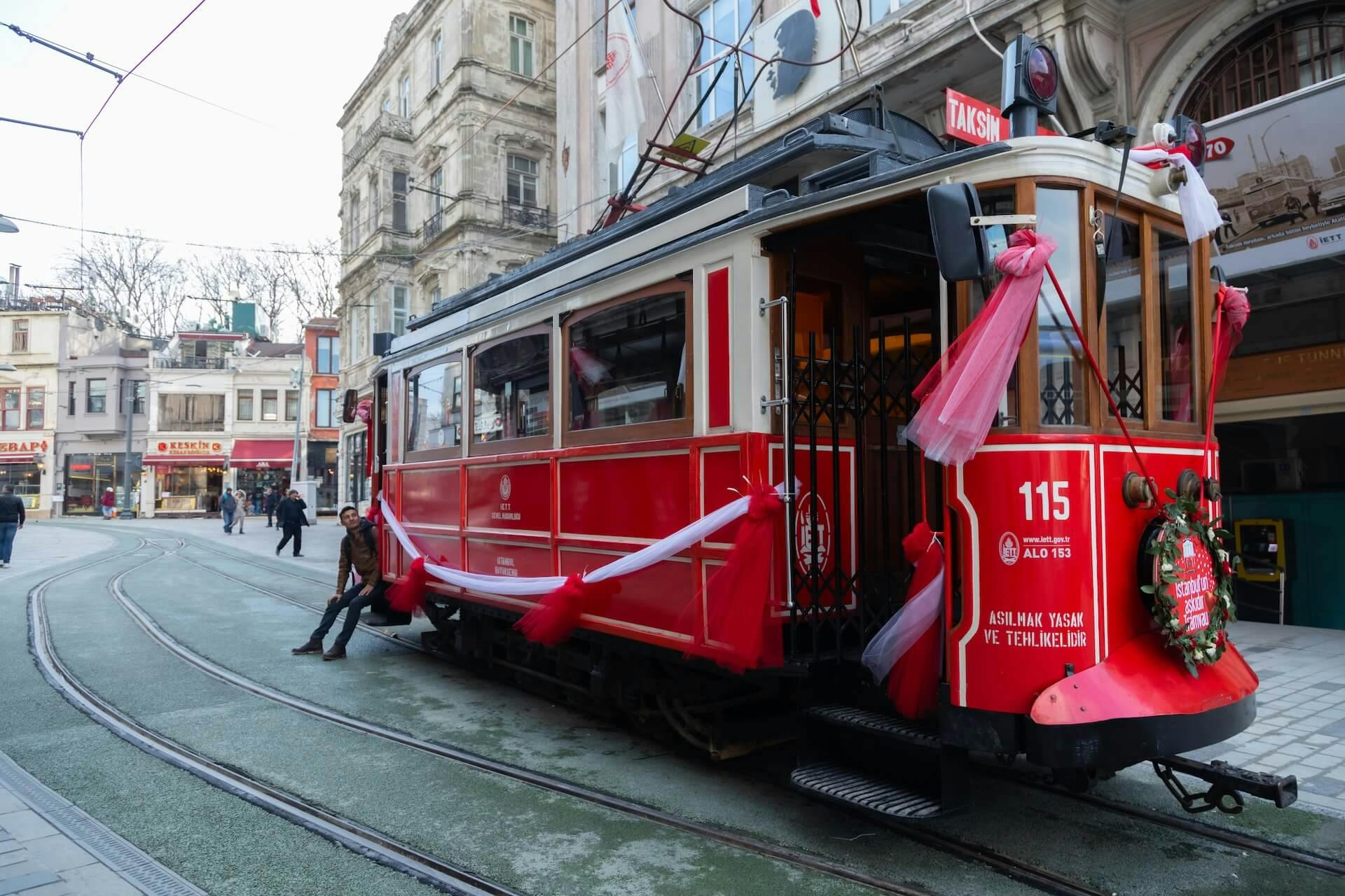 a red tram with a Christmas wreath in front