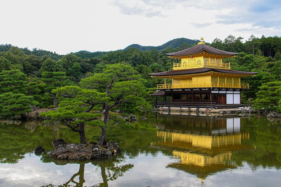 a yellow building sitting in the middle of a lake