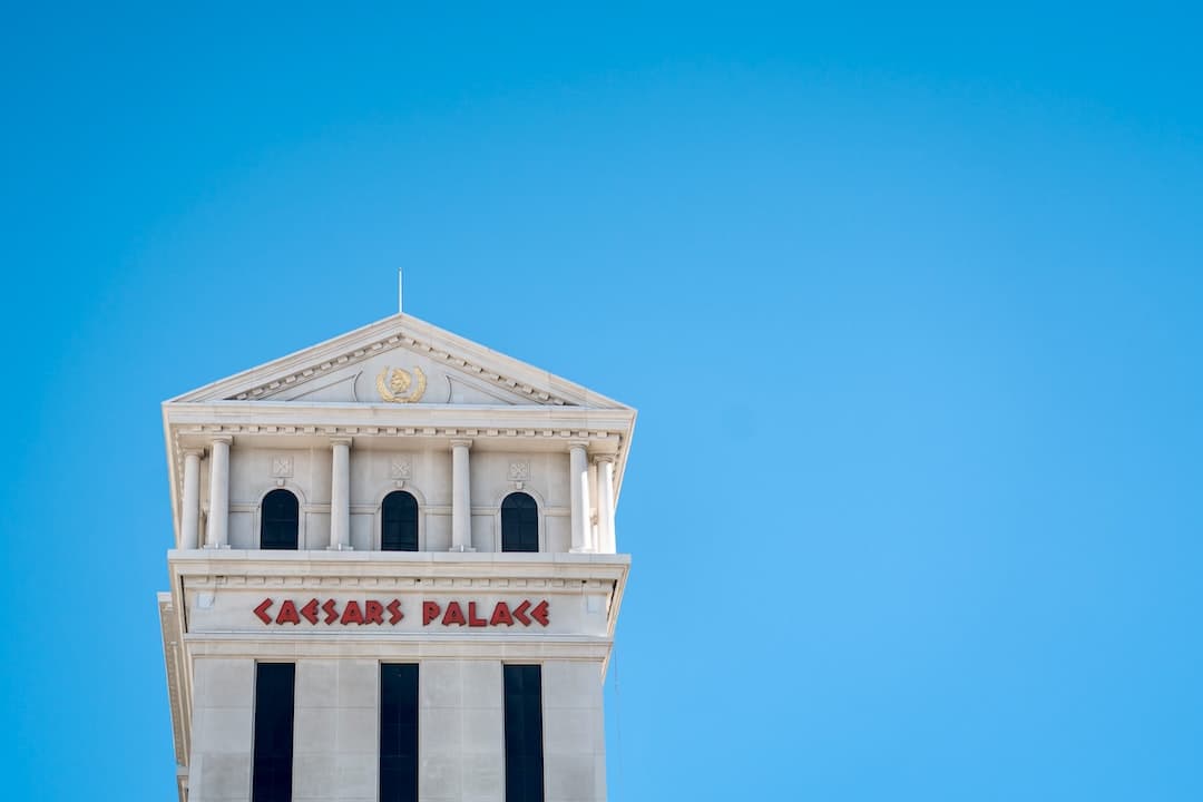 a tall white building with a clock on it's side