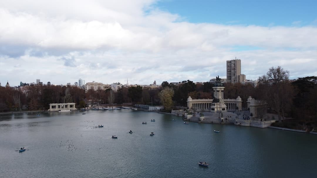 a body of water surrounded by trees and buildings