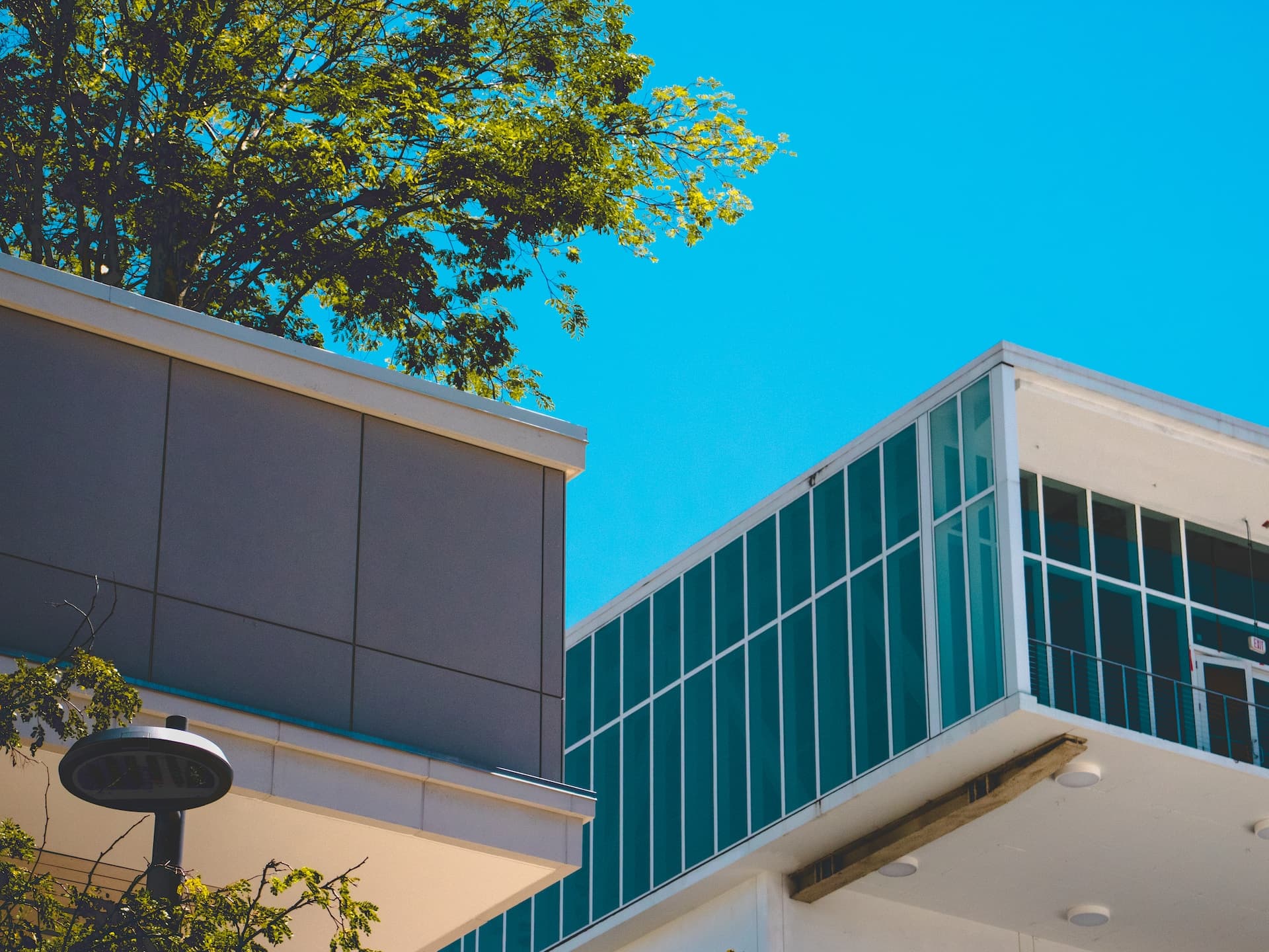 white concrete building near green trees during daytime
