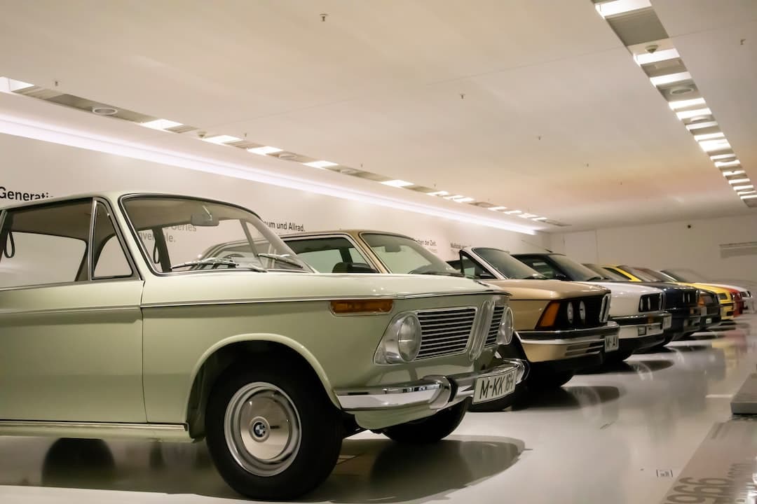 a row of old cars in a showroom