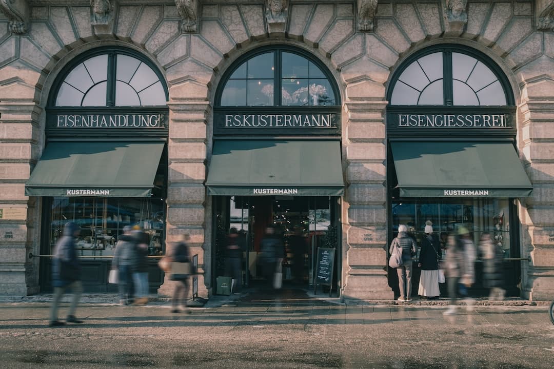 a group of people standing outside of a store