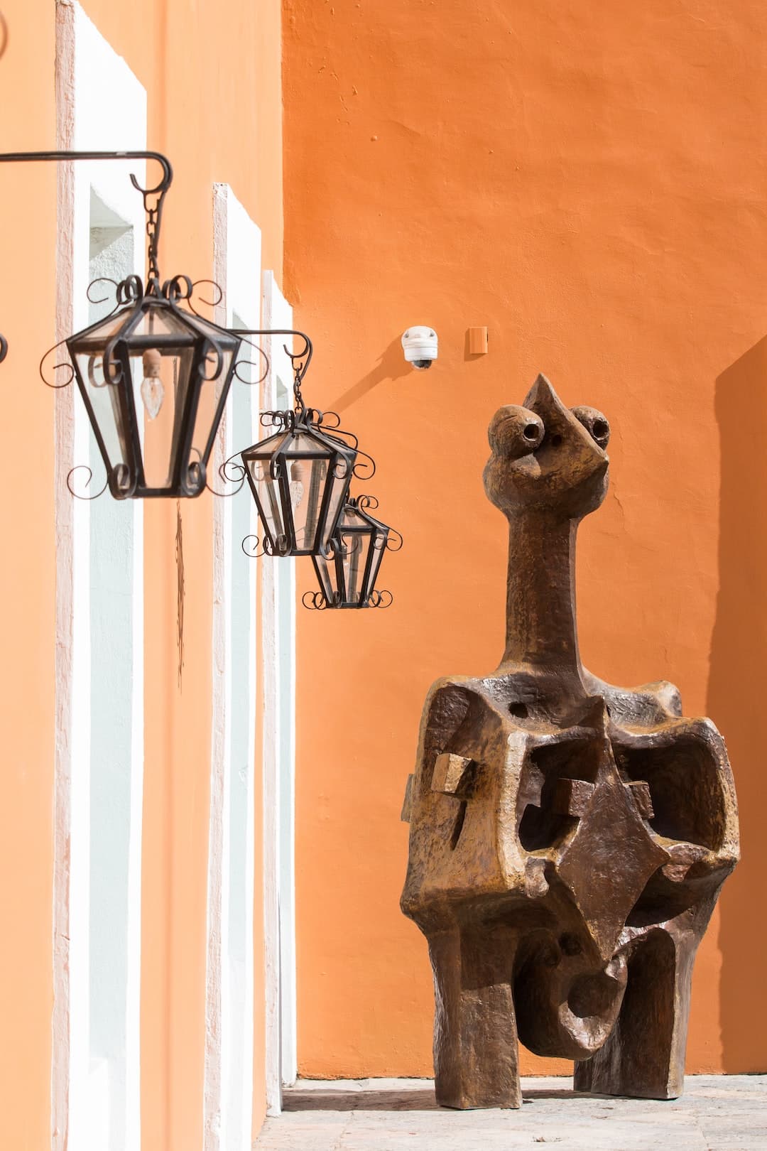 black metal candle holder on orange wall