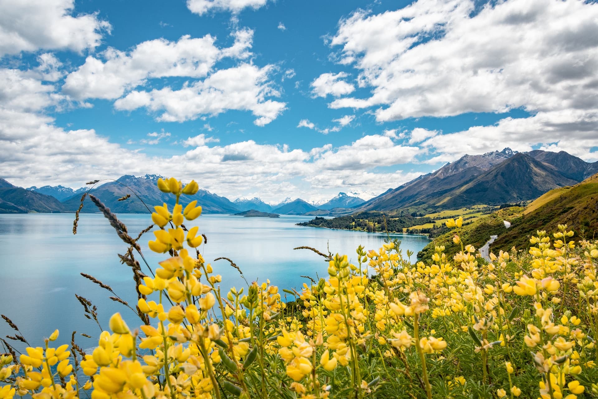 a scenic view of a mountain range with a road in the foreground