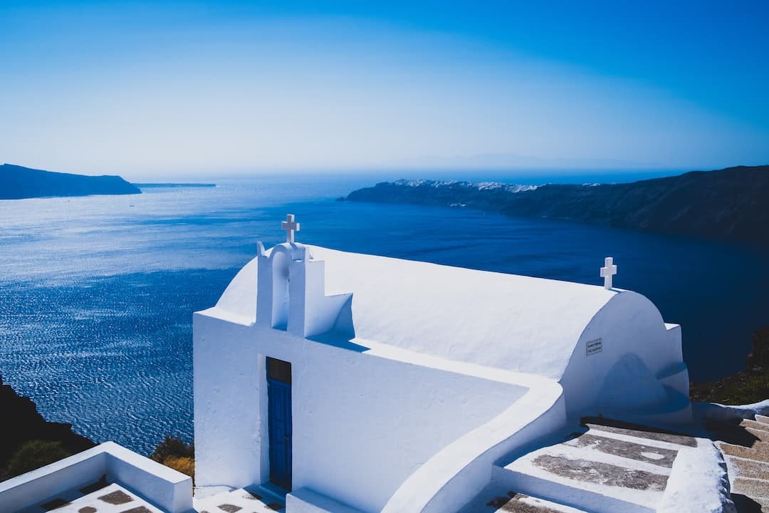 white concrete building near body of water during daytime