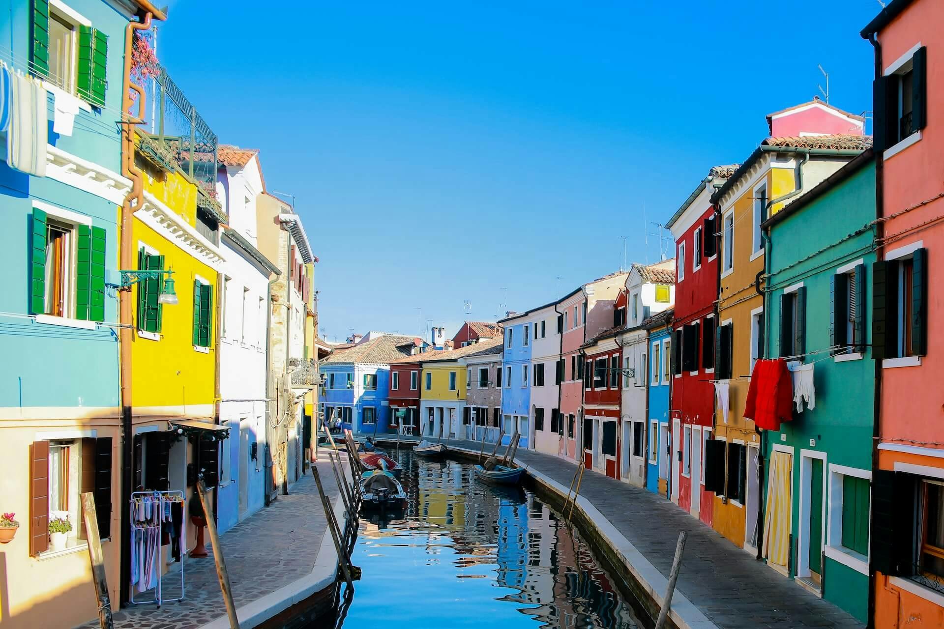 water canal between buildings of varied colors during the day