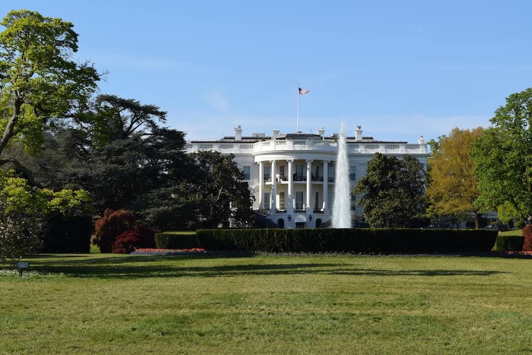 a large white building with a fountain in front of it