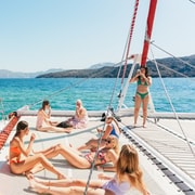 Santorini: Catamaran Tour with BBQ Dinner, Drinks, and Music